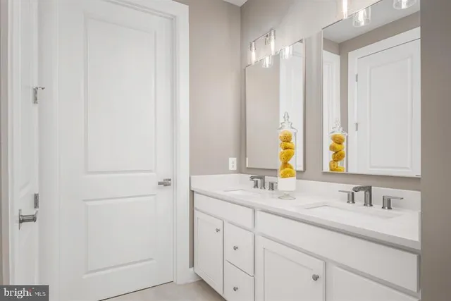 a bathroom with a double vanity sink and a mirror