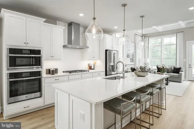 a kitchen with a stove a sink and a refrigerator