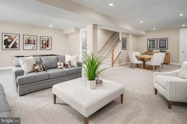 a living room with furniture and potted plant