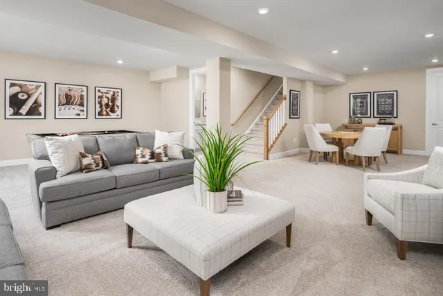 a living room with furniture and potted plant