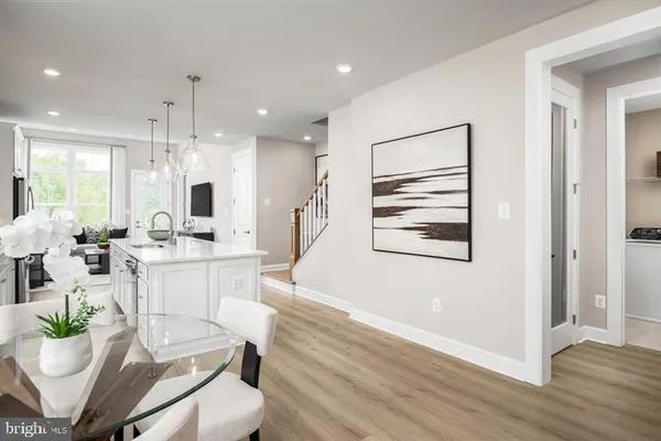 a room with stainless steel appliances kitchen island granite countertop furniture and a large window