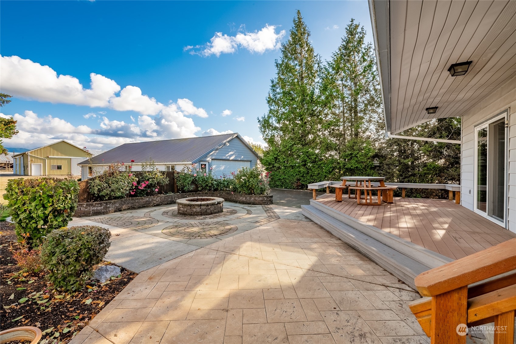 1243 Abbot Road Lynden, WA 98264 - Photo 26 of 40 a view of a patio with couches and table and chairs and potted plants