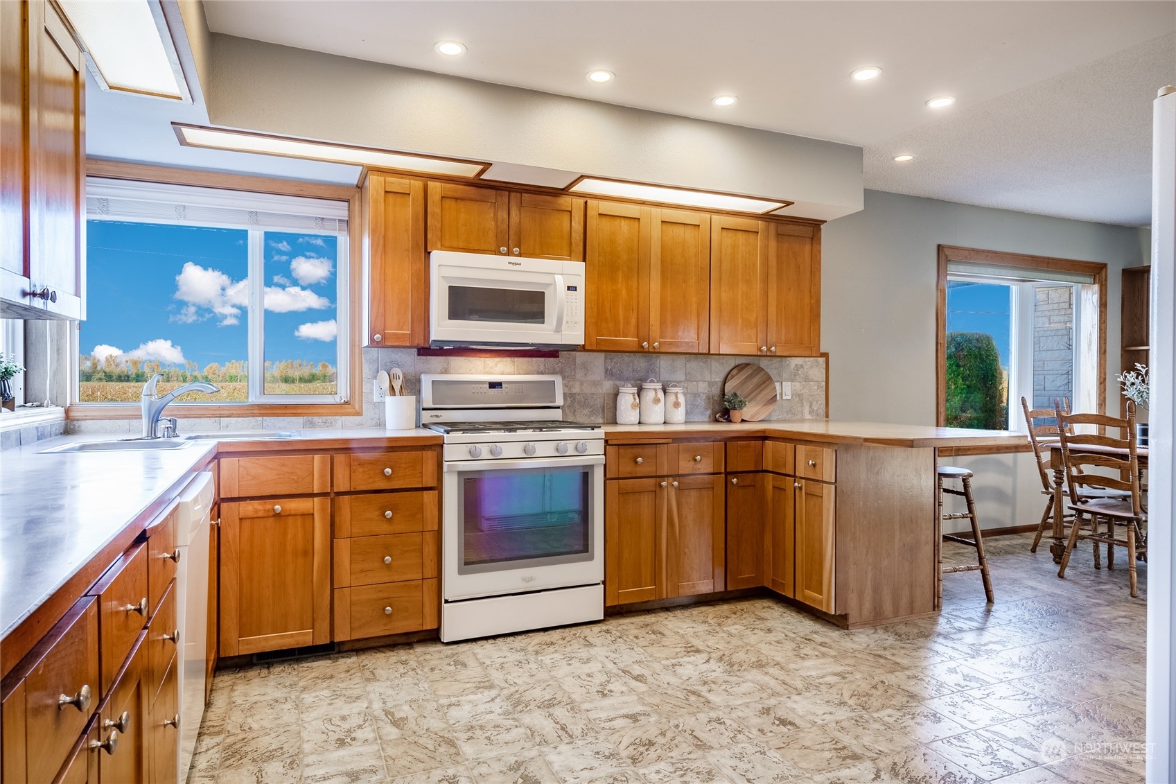 1243 Abbot Road Lynden, WA 98264 - Photo 27 of 40 a kitchen with stainless steel appliances granite countertop a stove a sink and a microwave