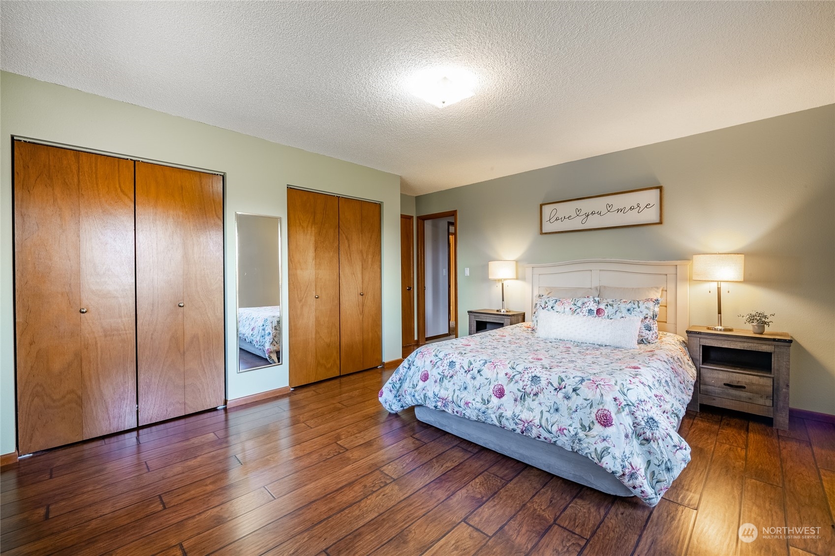 1243 Abbot Road Lynden, WA 98264 - Photo 31 of 40 a bedroom with a bed and wooden floor