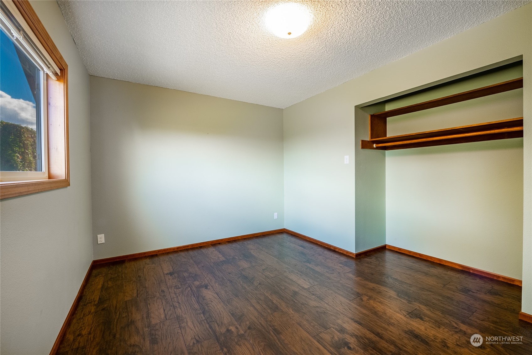 1243 Abbot Road Lynden, WA 98264 - Photo 34 of 40 a view of an empty room with wooden floor and a window