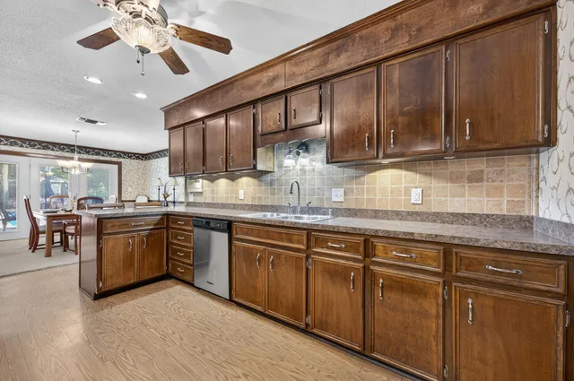 a bedroom with a large bed and a chandelier