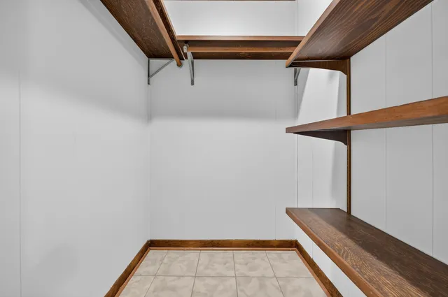 a view of a patio with a dining table and chairs with wooden fence