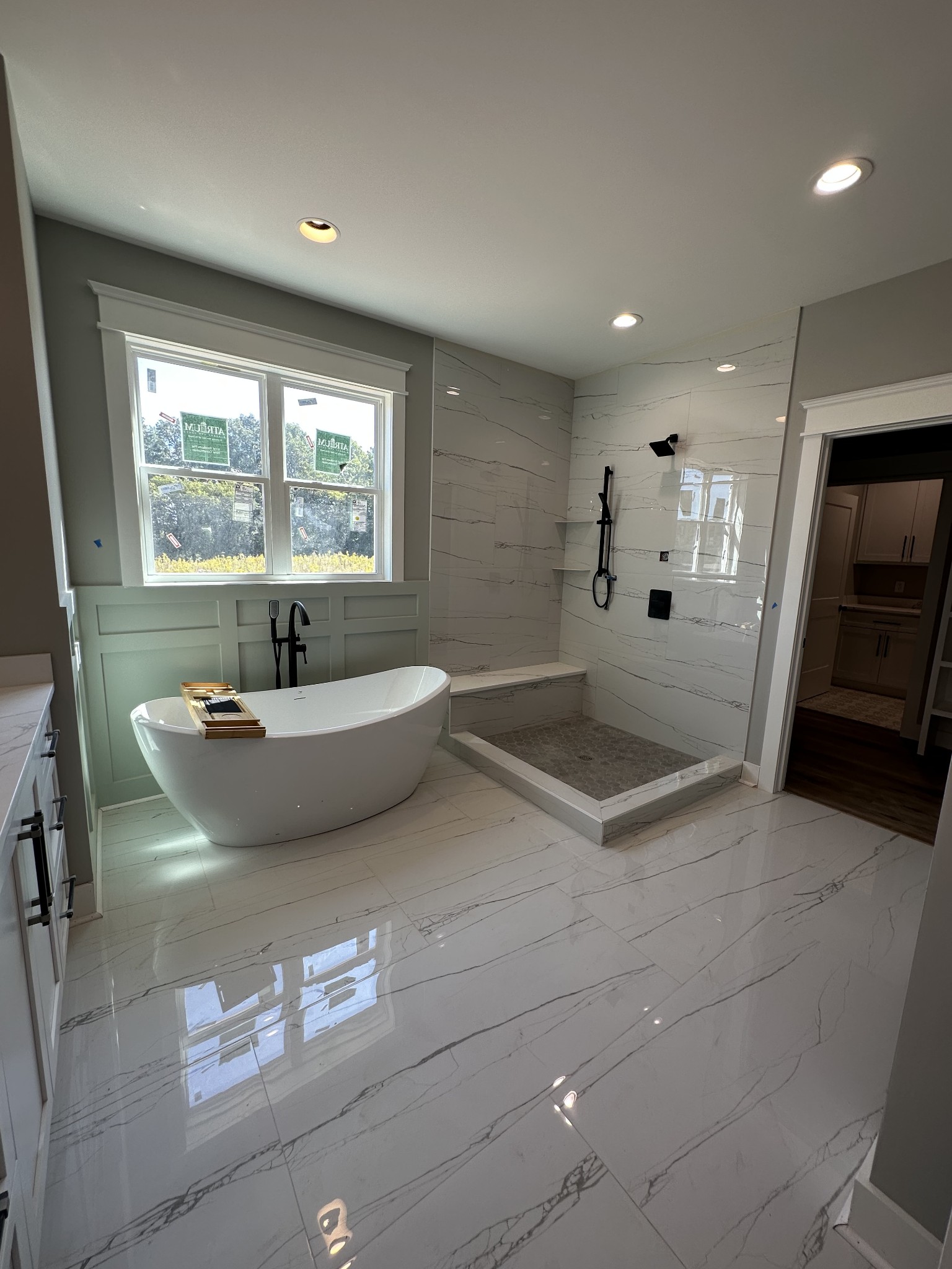 285 Aplin Branch Road Cottontown, TN 37048 - Photo 27 of 70 a bathroom with a tub a sink and a large mirror
