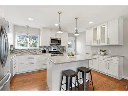 a kitchen with appliances a sink and cabinets