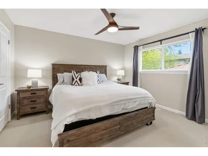 a bedroom with a bed and a large window