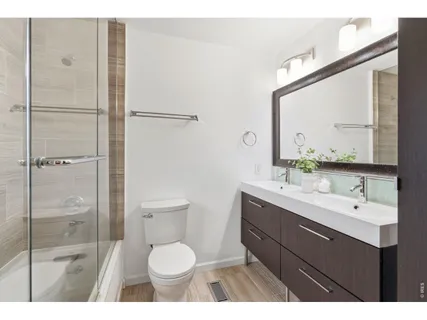 a bathroom with a sink toilet a mirror and shower