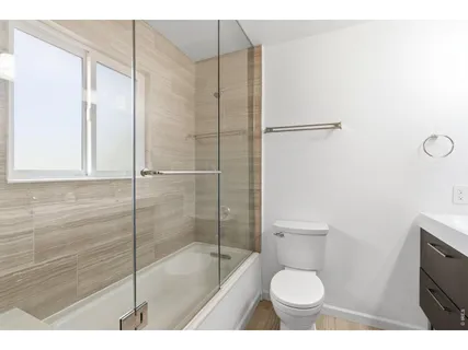 a bathroom with a toilet and a shower