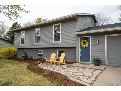 a view of a house with backyard and sitting area