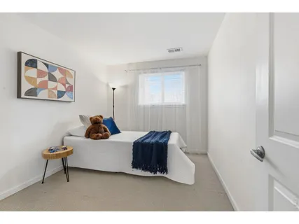 a living room with furniture and a wall painting