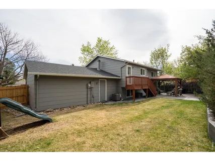 a view of a house with a yard and sitting area