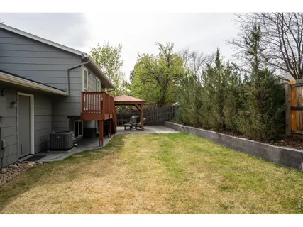 a swimming pool with outdoor seating and yard