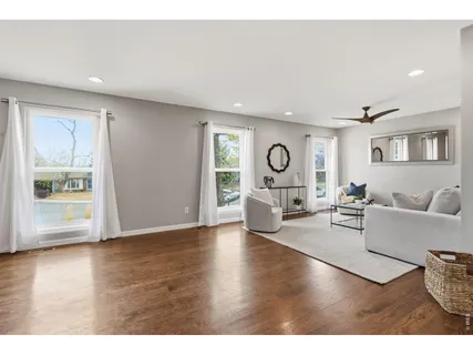 a living room with fireplace furniture and a wooden floor