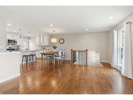 a living room with lots of furniture and kitchen view