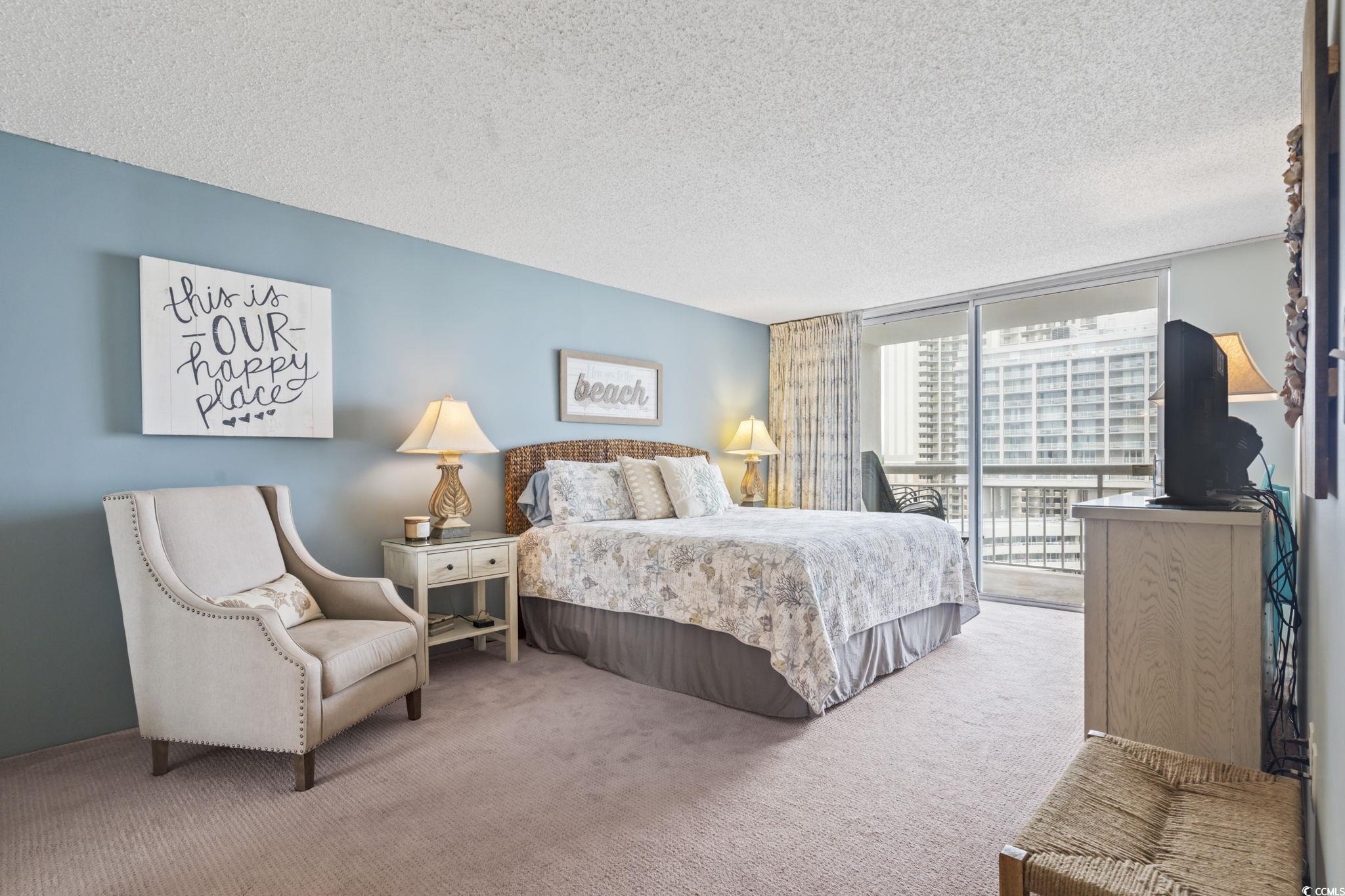 9820 Queensway Boulevard, Unit 1005 Myrtle Beach, SC 29572 - Photo 11 of 24 Carpeted bedroom featuring a textured ceiling, exp