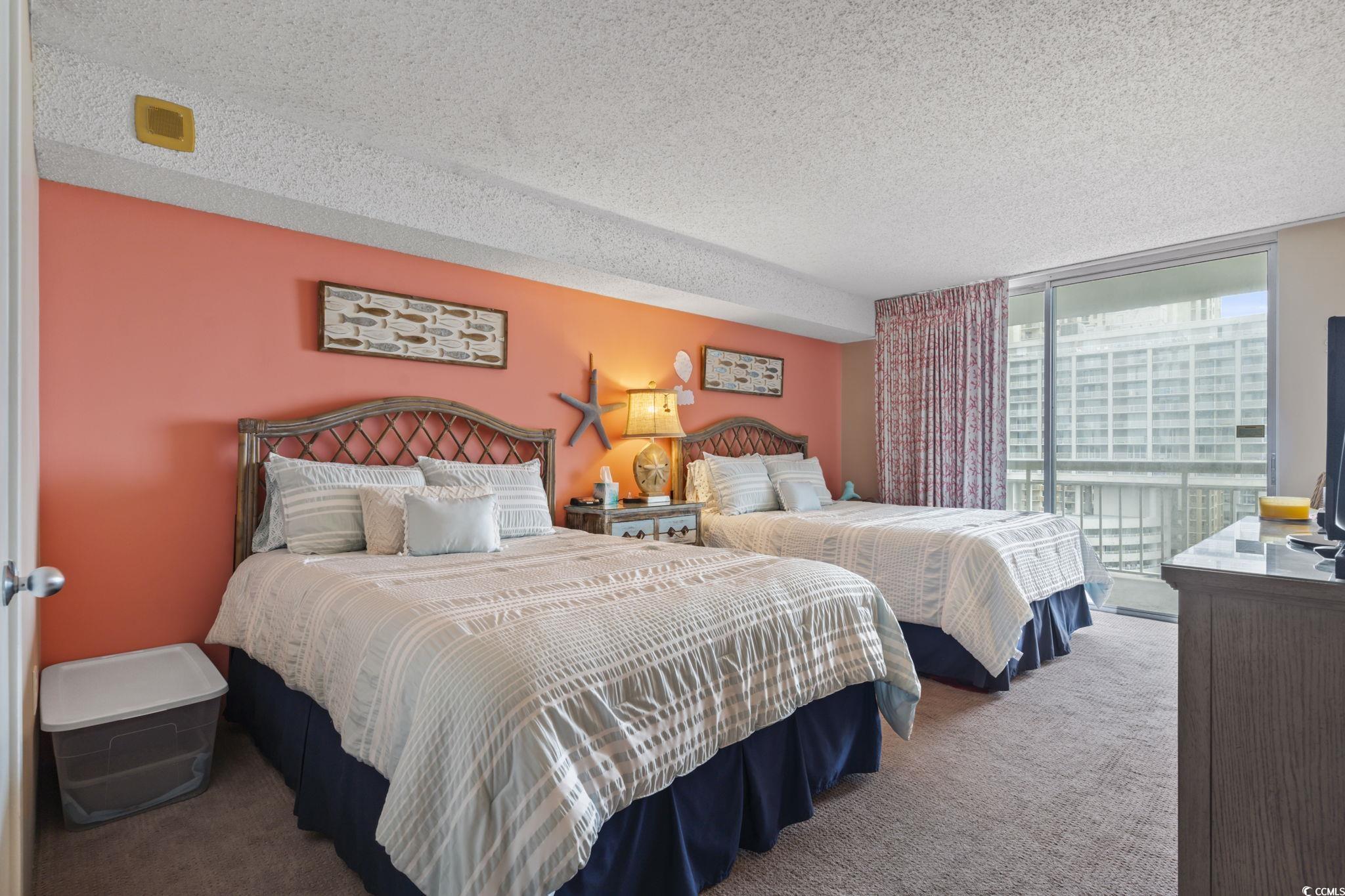 9820 Queensway Boulevard, Unit 1005 Myrtle Beach, SC 29572 - Photo 13 of 24 Bedroom featuring a textured ceiling, carpet, and