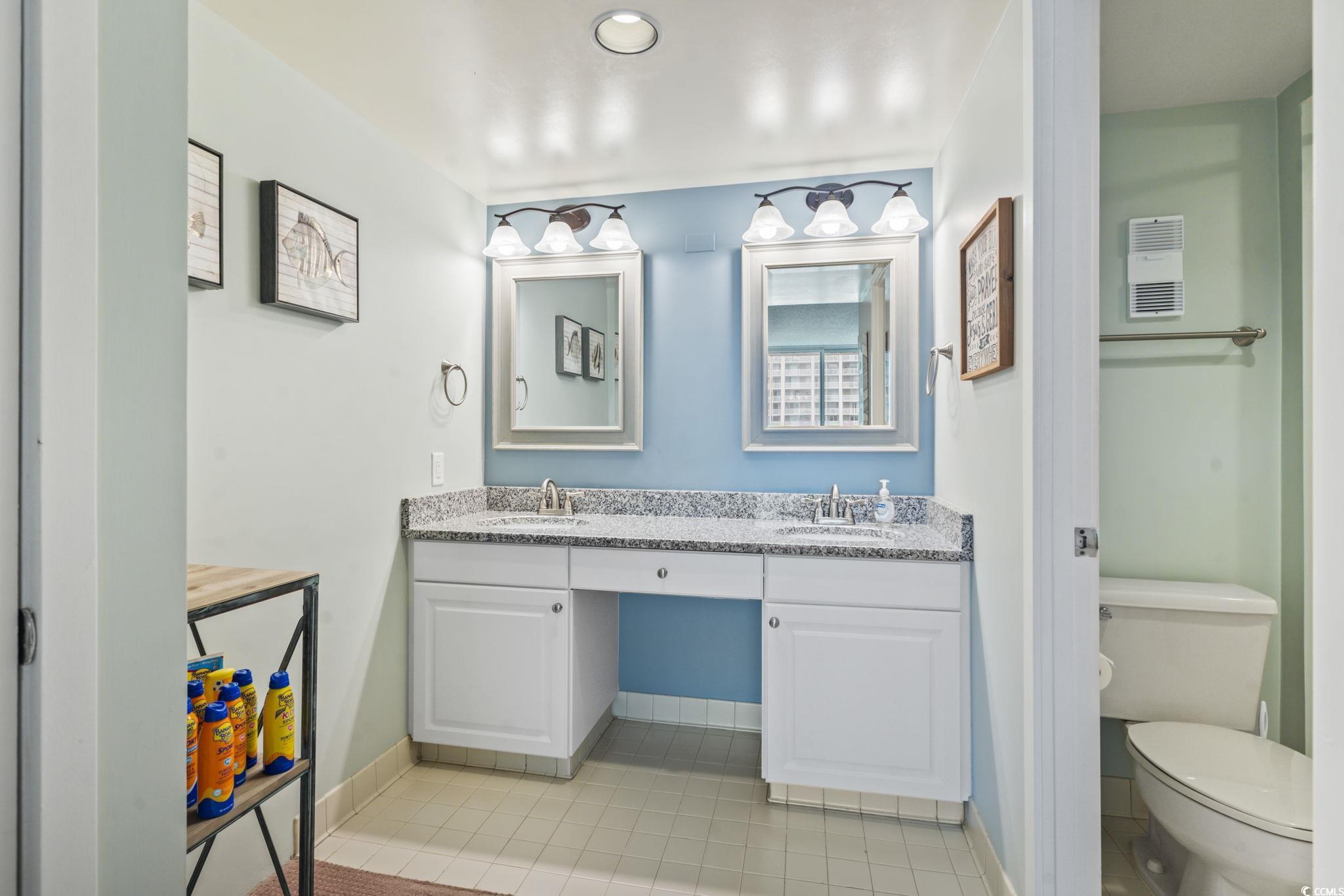 9820 Queensway Boulevard, Unit 1005 Myrtle Beach, SC 29572 - Photo 14 of 24 Bathroom featuring double vanity and light tile pa