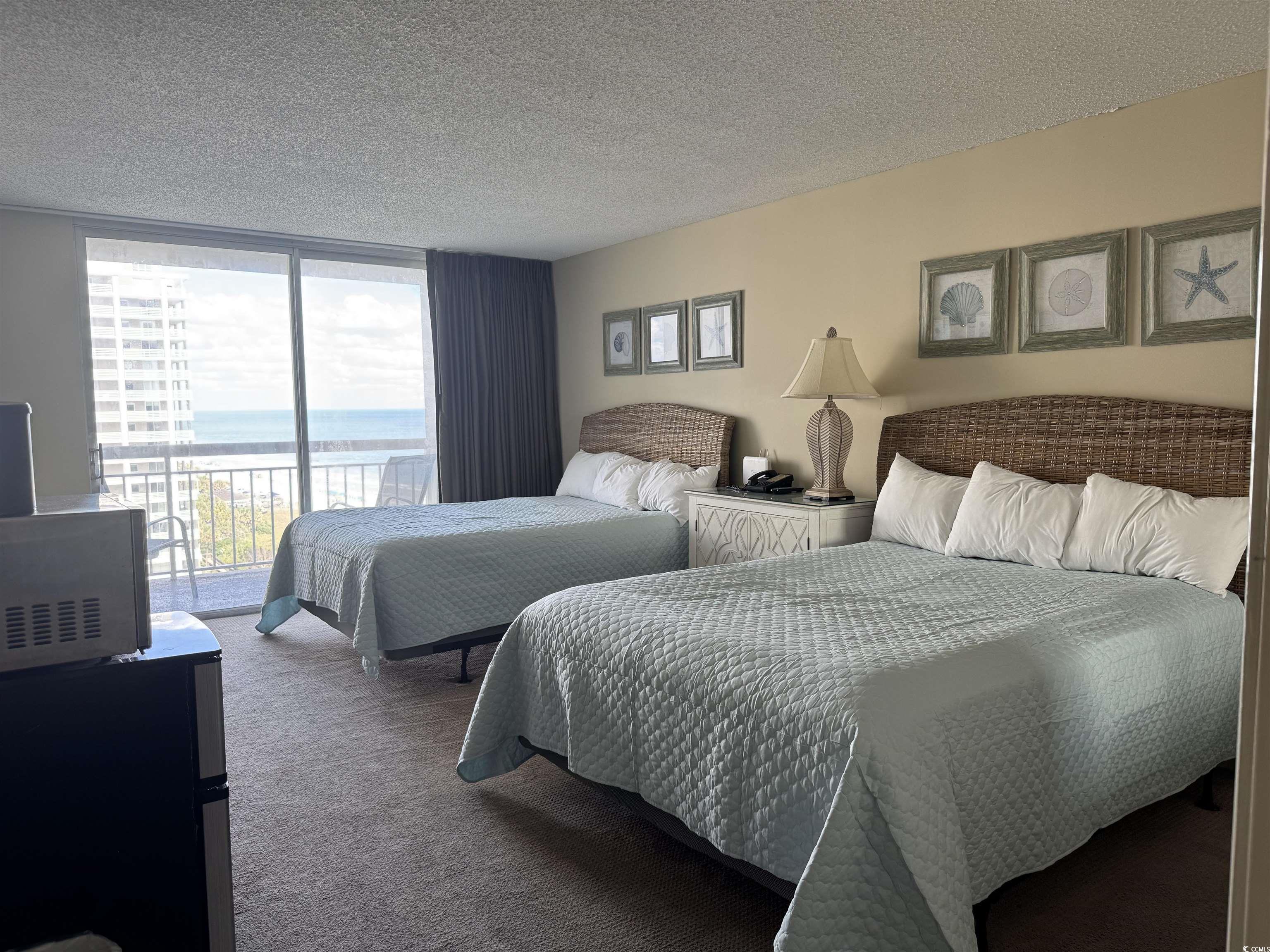 9820 Queensway Boulevard, Unit 1005 Myrtle Beach, SC 29572 - Photo 16 of 24 Carpeted bedroom featuring access to exterior, a t