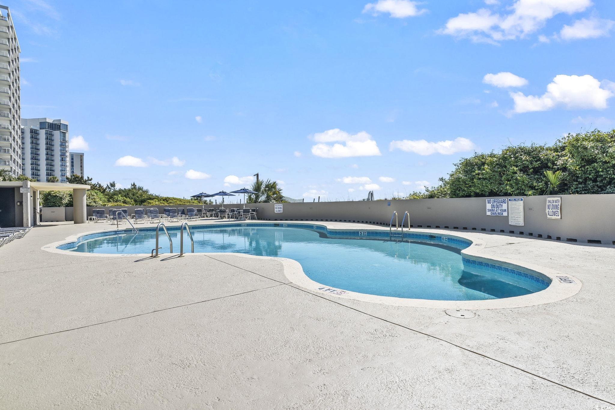 9820 Queensway Boulevard, Unit 1005 Myrtle Beach, SC 29572 - Photo 20 of 24 Community pool with a patio