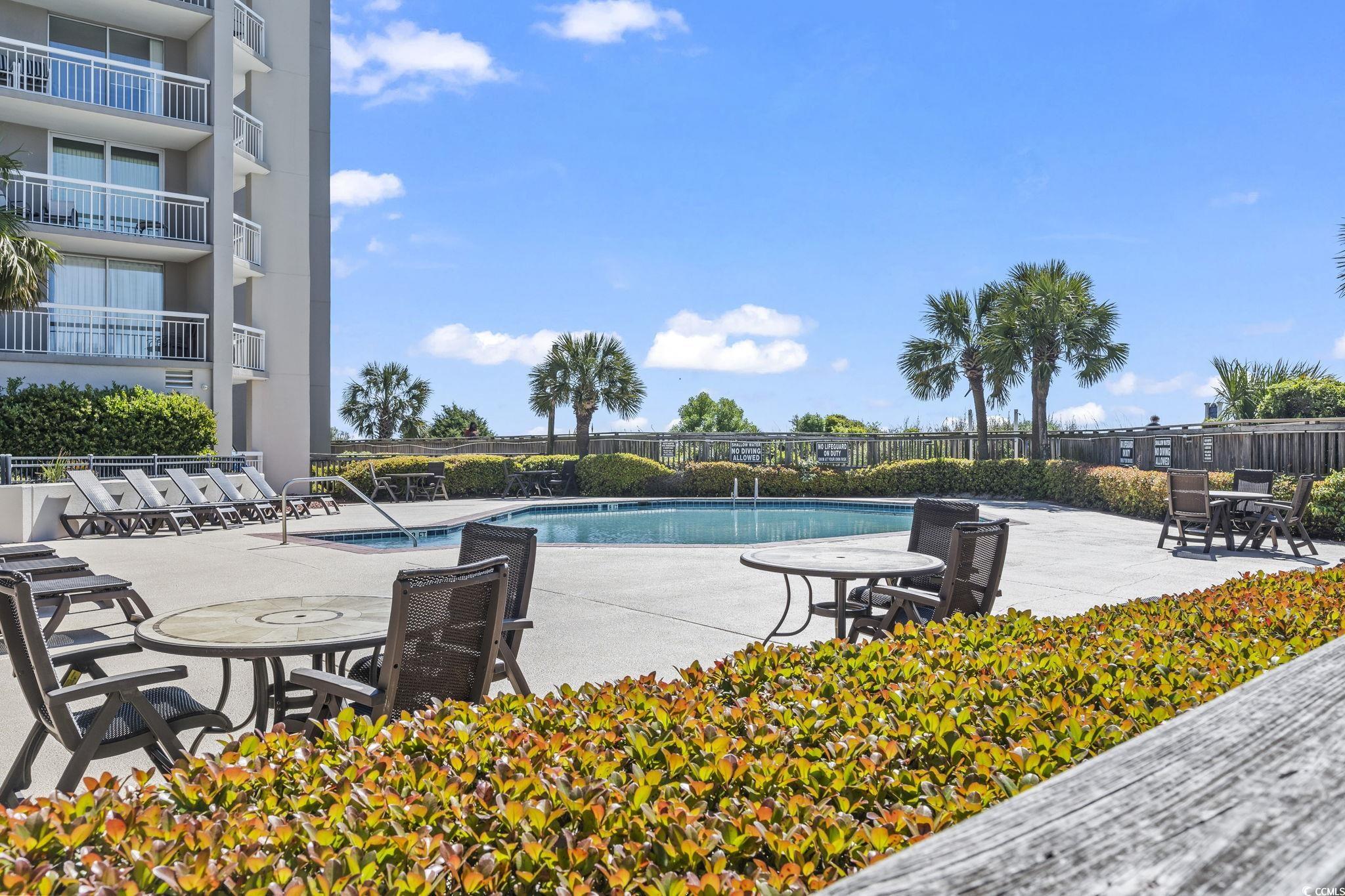 9820 Queensway Boulevard, Unit 1005 Myrtle Beach, SC 29572 - Photo 22 of 24 Community pool with a patio