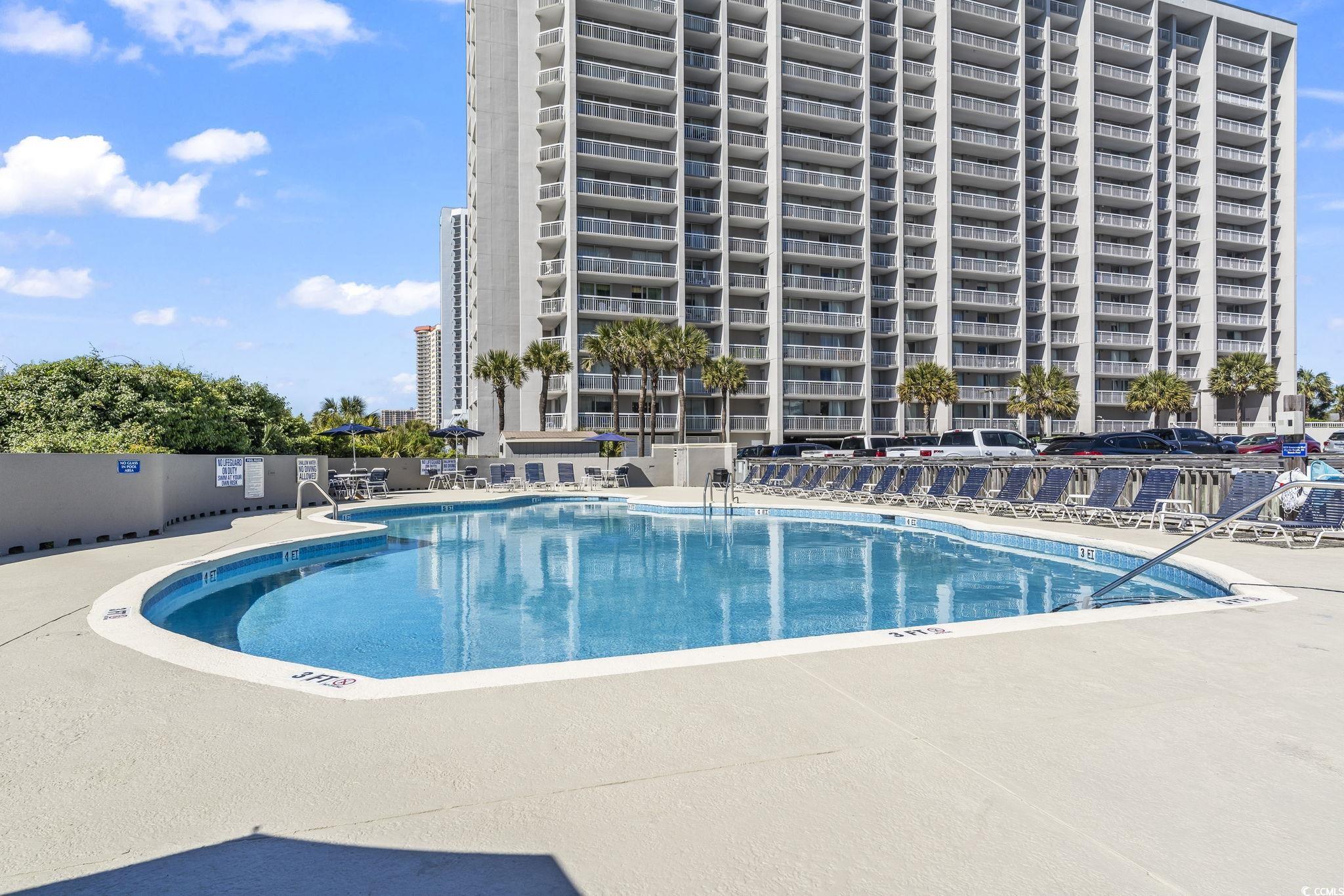 9820 Queensway Boulevard, Unit 1005 Myrtle Beach, SC 29572 - Photo 4 of 24 Community pool with a patio