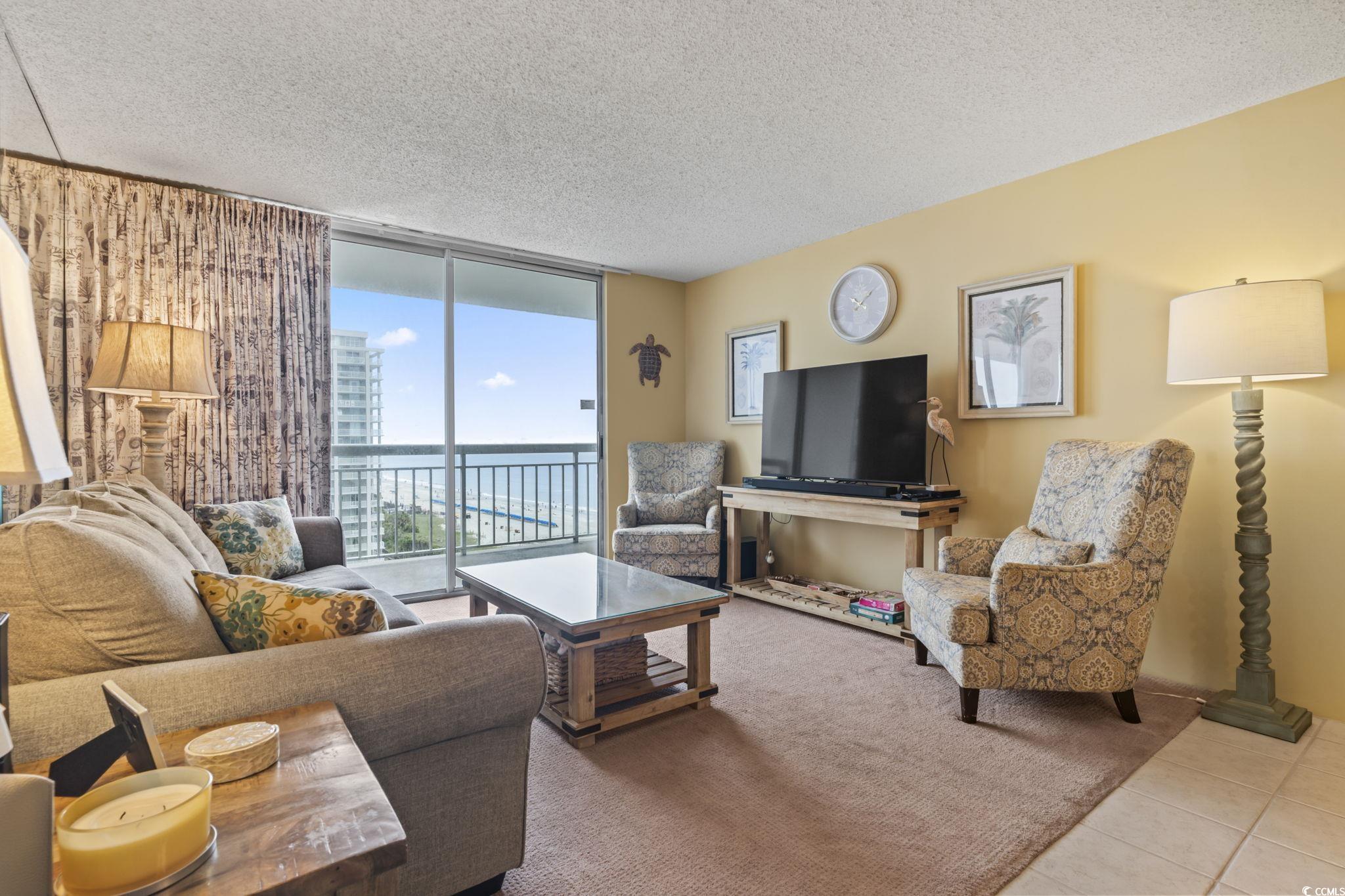 9820 Queensway Boulevard, Unit 1005 Myrtle Beach, SC 29572 - Photo 5 of 24 Living area featuring a wall of windows, a texture