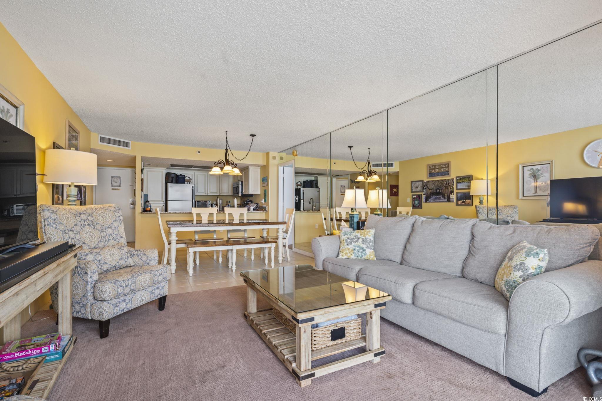 9820 Queensway Boulevard, Unit 1005 Myrtle Beach, SC 29572 - Photo 7 of 24 Living room featuring a textured ceiling