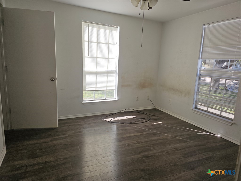 1001 South 29th Street Temple, TX 76504 - Photo 14 of 14 an empty room with wooden floor and windows