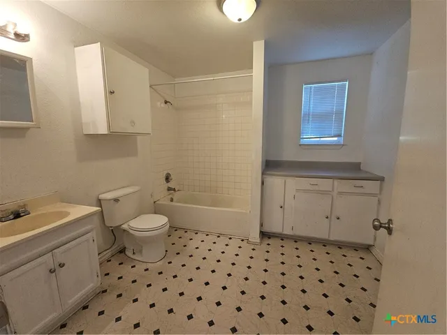 a bathroom with a sink a toilet and a shower