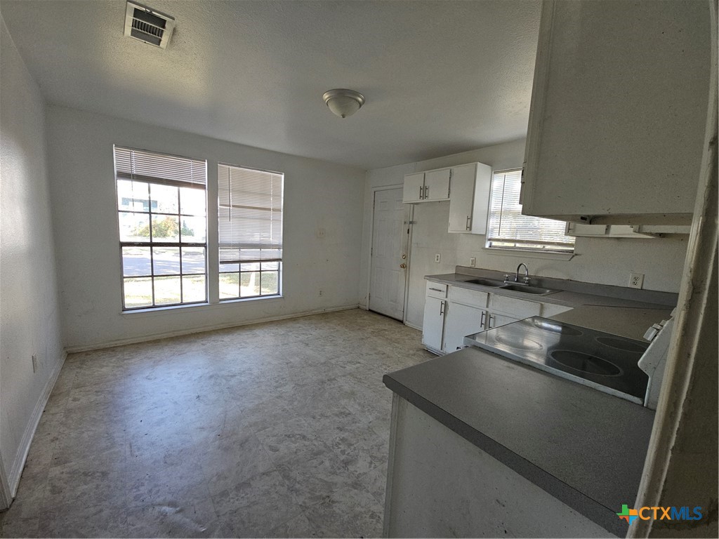 1001 South 29th Street Temple, TX 76504 - Photo 10 of 14 a kitchen with a sink stove and cabinets