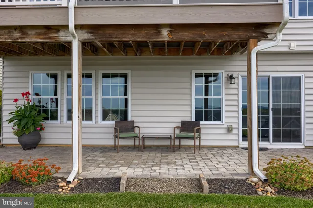 a view of a hallway with wooden floor and a chandelier