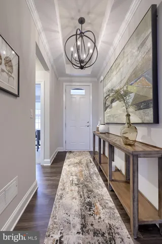 a large white kitchen with lots of furniture and appliances