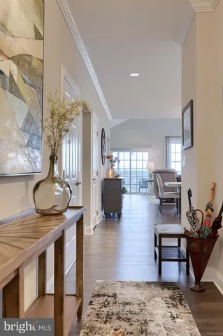 a kitchen with kitchen island granite countertop a sink cabinets and wooden floor