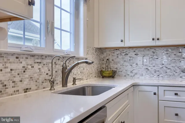 a view of a dining room with furniture a chandelier and wooden floor