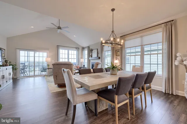 a living room with furniture kitchen view and a flat screen tv