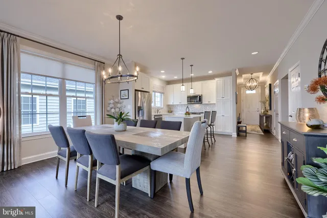 a dining room with furniture window and wooden floor