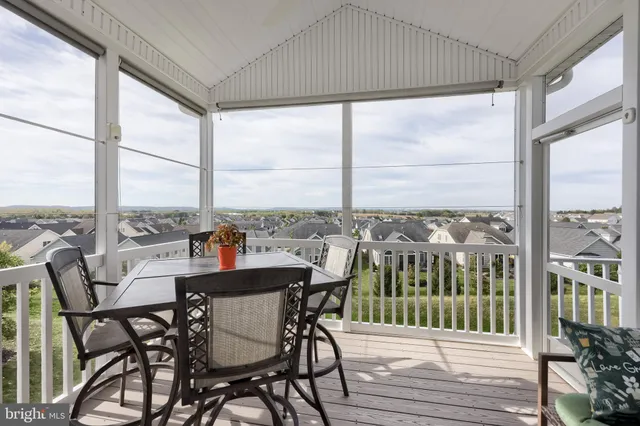 a view of a livingroom with furniture wooden floor and window