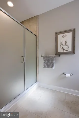 a bedroom with a bed a couch and a chandelier