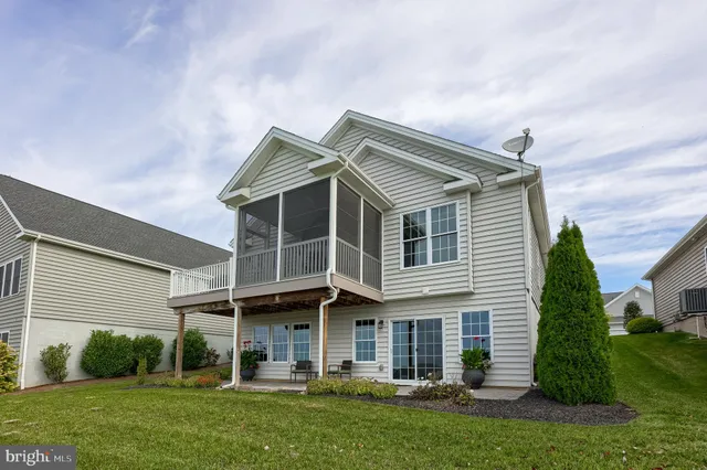 a front view of a house with a garden and plants