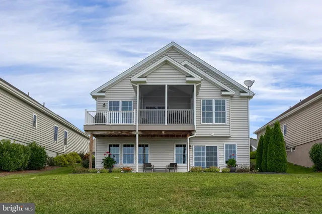 a view of a house with a yard and sitting area