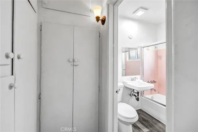 a bathroom with a toilet a sink and mirror