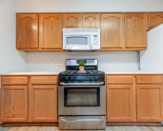 a stove top oven sitting inside of a kitchen