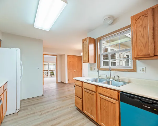 a kitchen with stainless steel appliances granite countertop a sink and wooden cabinets