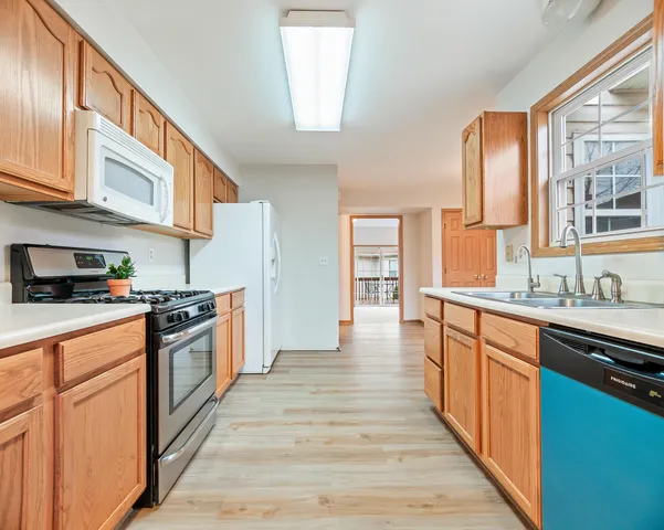 a large kitchen with stainless steel appliances granite countertop a stove and a sink
