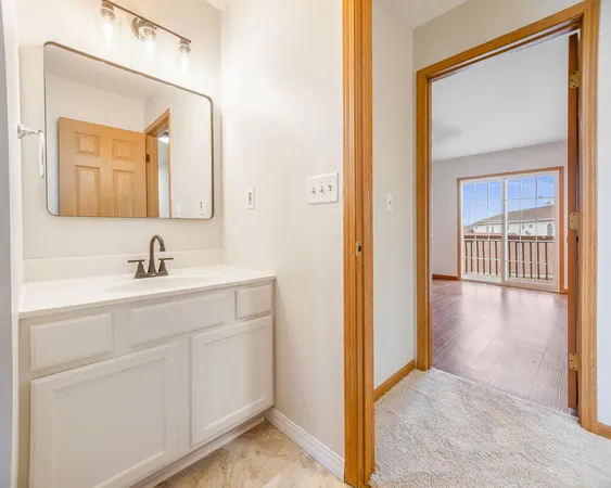 a en suite bathroom with a sink and a mirror