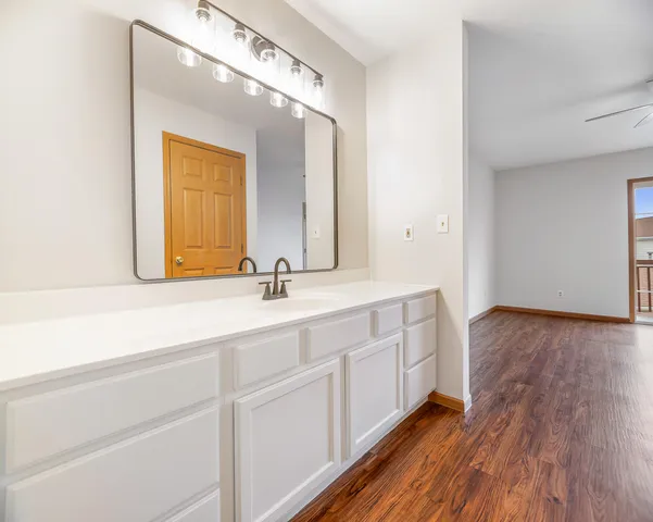 a bathroom with a double vanity sink and a mirror